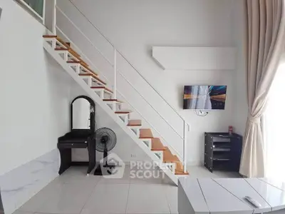 Modern duplex living room with stylish staircase and wall-mounted TV