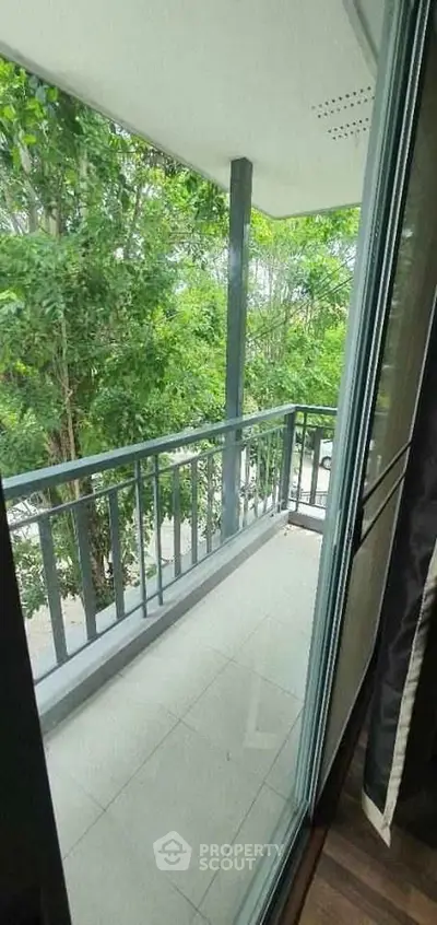 Charming balcony with lush green views, perfect for relaxation and enjoying nature.