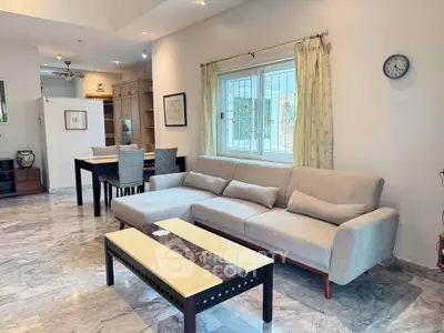 Spacious living room with elegant marble flooring and modern furniture