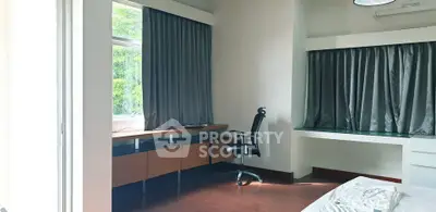 Spacious study room with modern desk and ergonomic chair, featuring large windows and natural light.