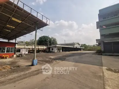 Spacious industrial property with ample outdoor space and multiple warehouse buildings.