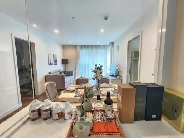 Elegant living room with dining area, modern decor, and natural light.