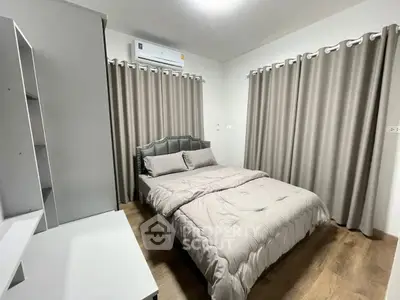 Cozy bedroom with modern decor and ample natural light