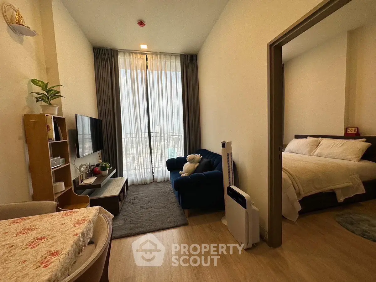 Cozy apartment interior with living room and bedroom, featuring modern decor and natural light.