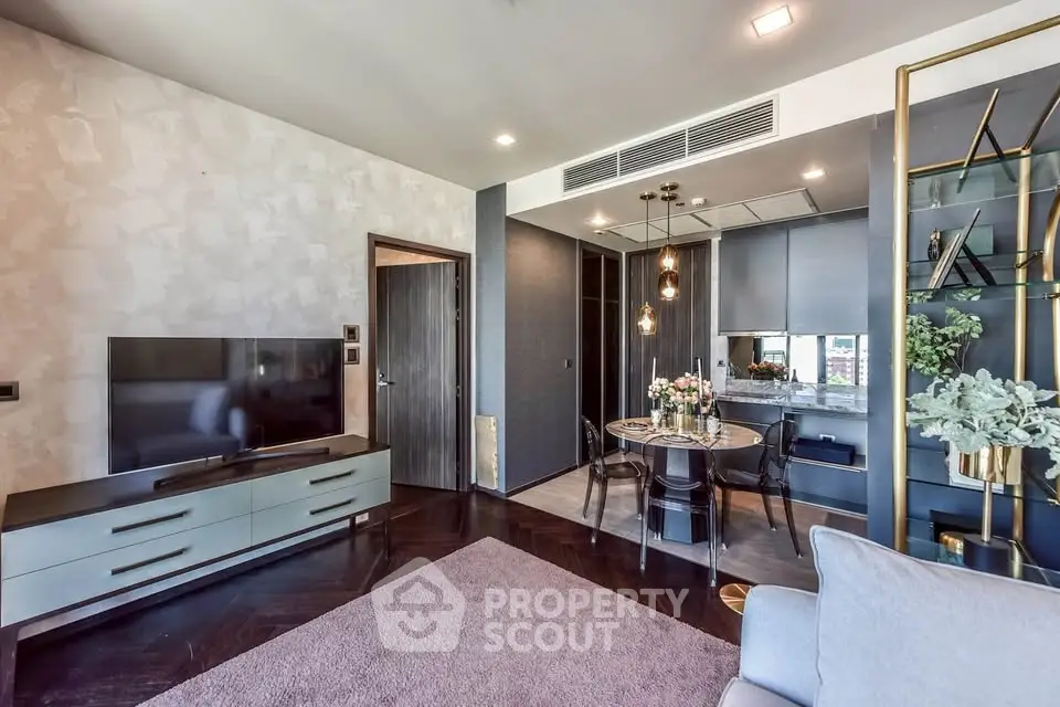 Modern living room with open kitchen, stylish decor, and cozy dining area.