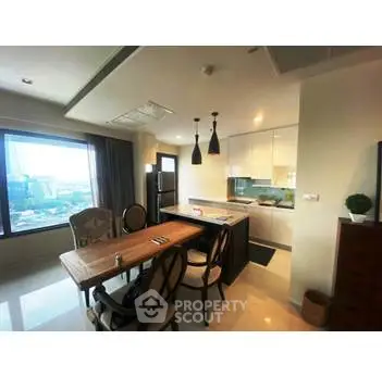 Modern open-layout kitchen with dining area and large window view