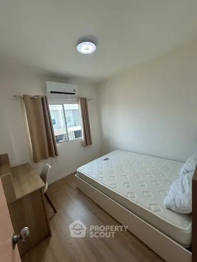Cozy bedroom with natural light, featuring a comfortable bed and study desk, perfect for relaxation and productivity.