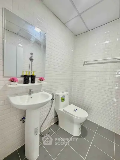 Modern bathroom with white subway tiles and sleek fixtures