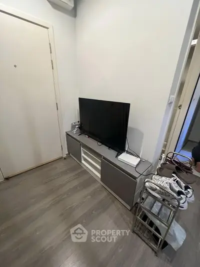 Modern living room corner with sleek TV stand and wooden flooring