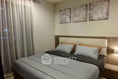 Cozy bedroom with elegant decor and soft lighting, featuring a comfortable bed and stylish wall art.