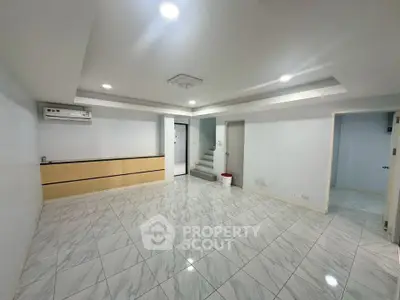 Spacious tiled living room with modern lighting and air conditioning