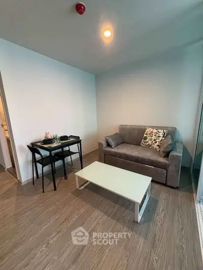 Cozy living room with modern sofa and dining table in a stylish apartment.