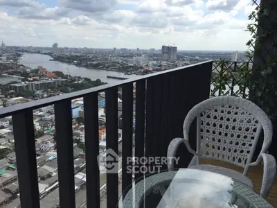 Stunning high-rise balcony with panoramic city and river views, perfect for relaxation.