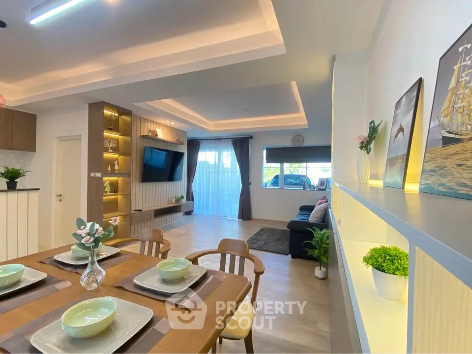 Modern living room with stylish decor and open layout, featuring elegant dining area and cozy seating.