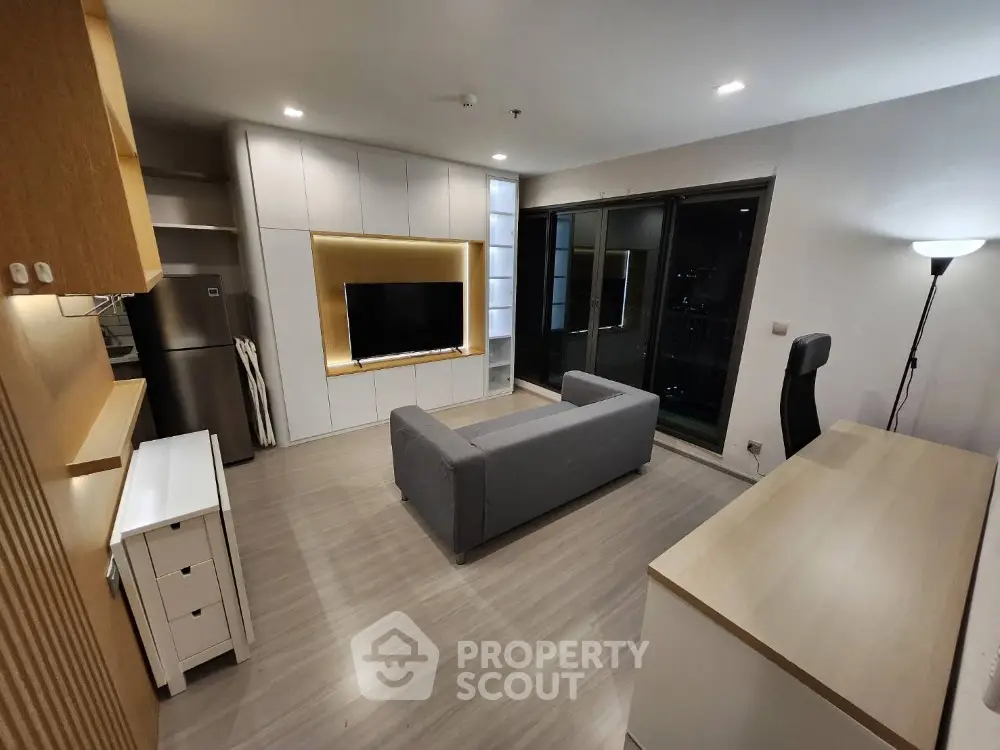 Modern living room with sleek design and large TV, perfect for urban living.