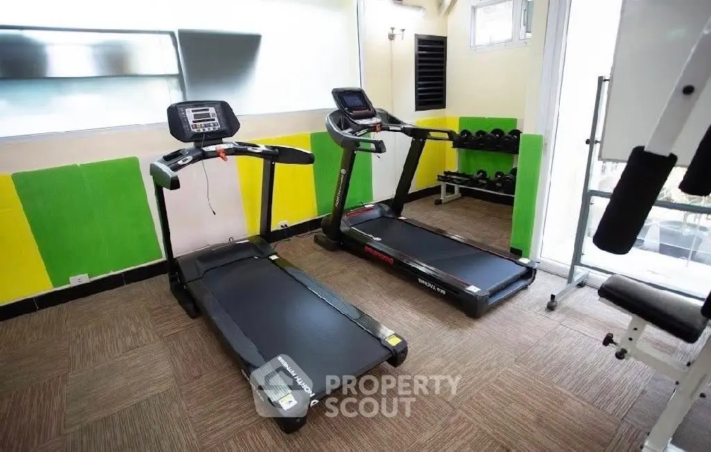 Modern gym with treadmills and weights in a vibrant fitness area