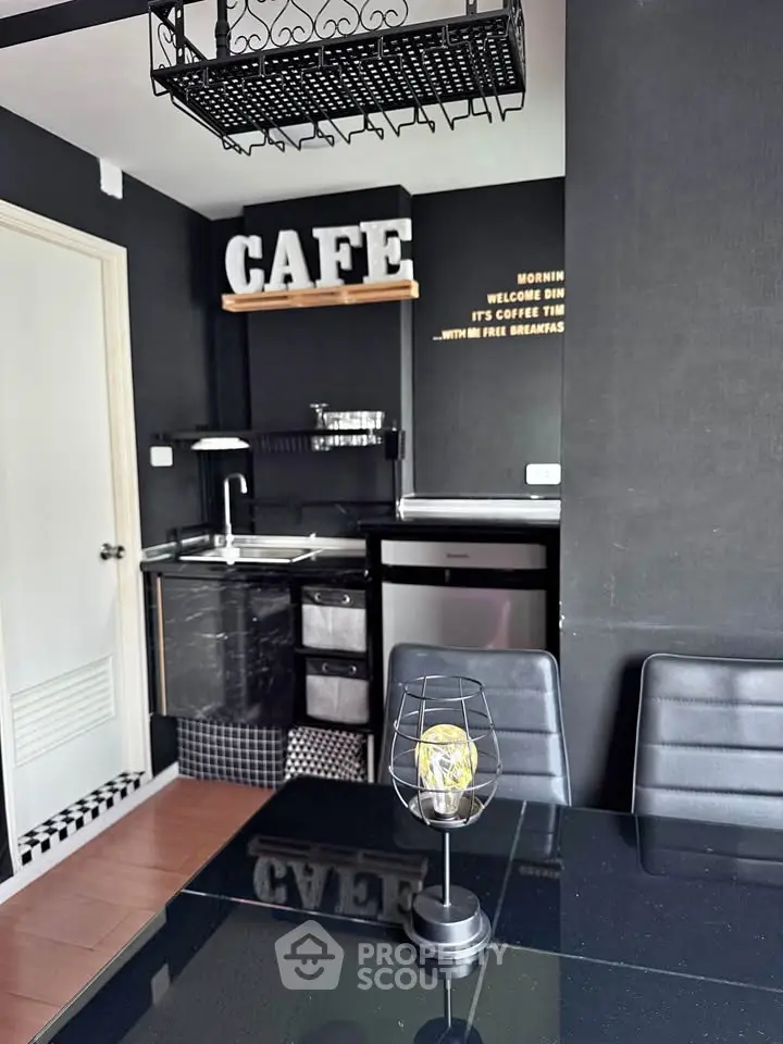 Chic modern kitchen with black decor and stylish cafe theme, featuring compact appliances and sleek dining area.
