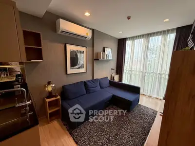 Modern living room with blue sofa and large window, stylish decor