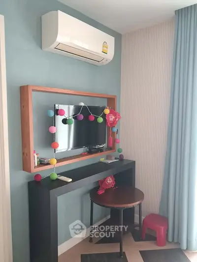 Charming living room corner with modern decor and wall-mounted TV
