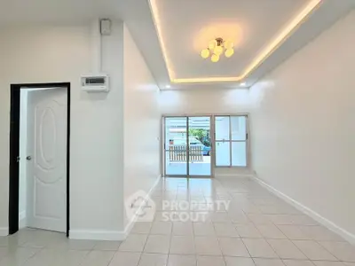 Spacious and bright living room with modern lighting and large windows.