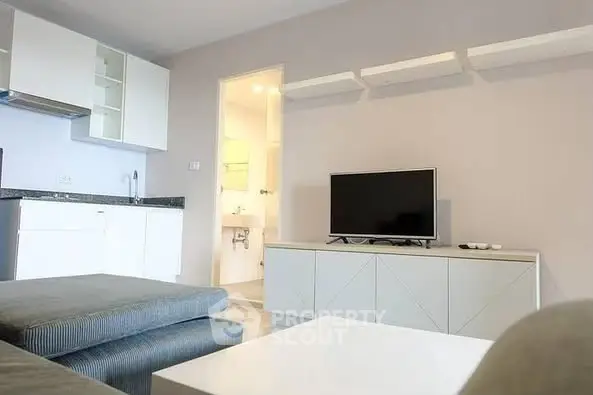 Modern living room with sleek furniture and wall-mounted shelves.