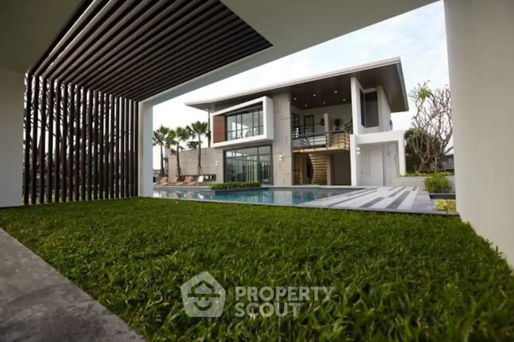 Luxurious modern home with pool and lush garden, perfect for upscale living.