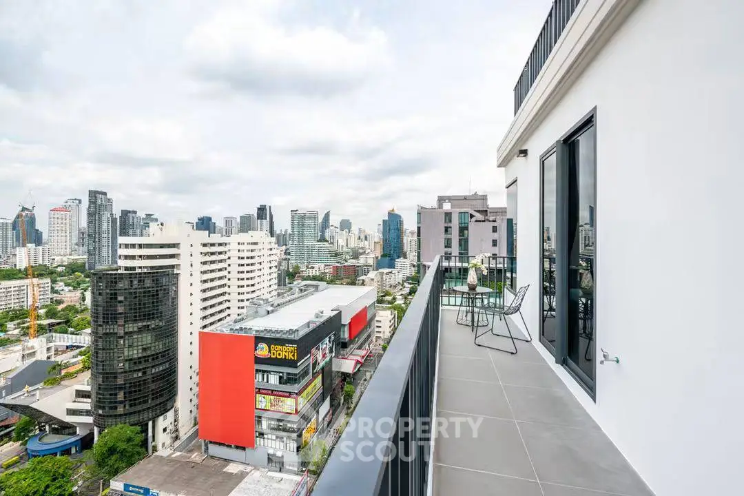 Stunning cityscape view from modern high-rise balcony with sleek design.