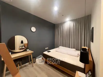 Modern bedroom with stylish decor and cozy ambiance, featuring a sleek desk and comfortable bed.