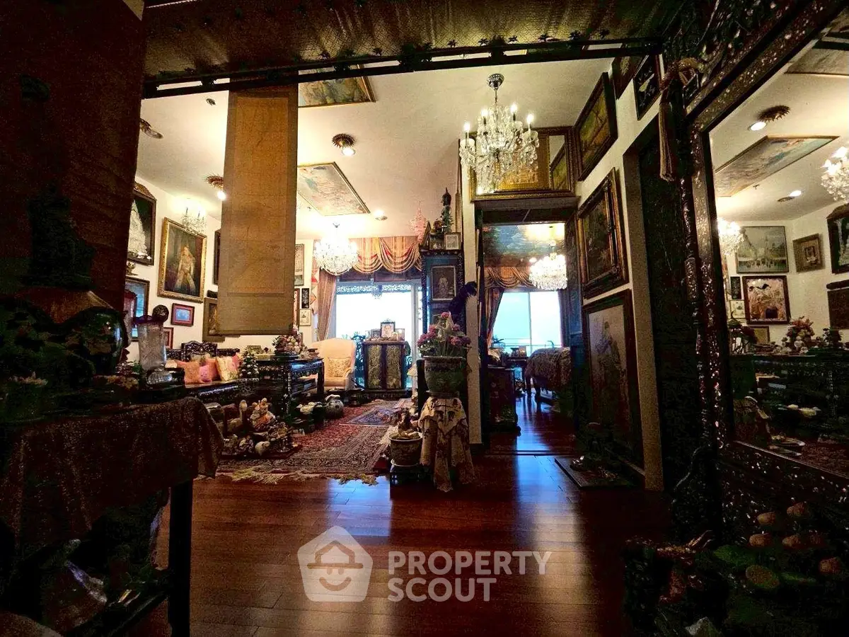 Luxurious living room with elegant decor and chandeliers, showcasing opulent interior design.