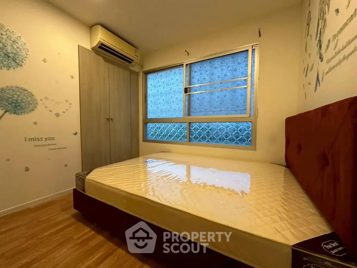Cozy bedroom with air conditioning and stylish decor, perfect for relaxation.