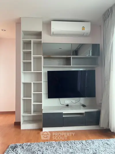 Modern living room with sleek entertainment unit and air conditioning