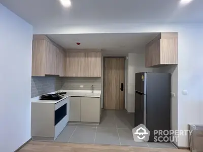 Modern kitchen with sleek cabinetry and stainless steel appliances in a contemporary apartment.