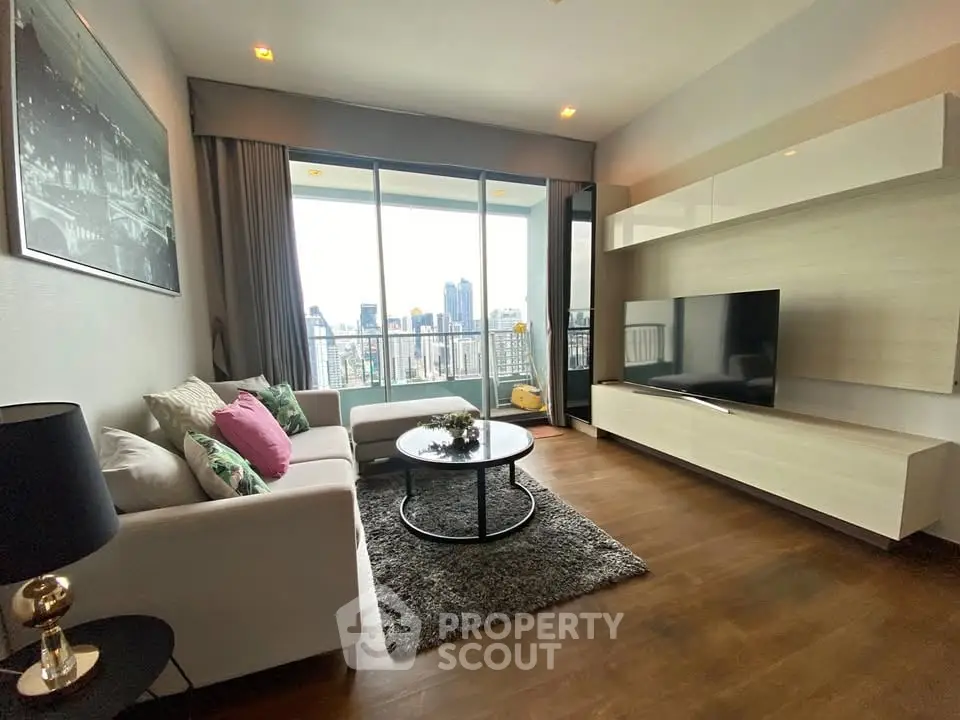 Modern living room with city view, stylish decor, and large TV setup.