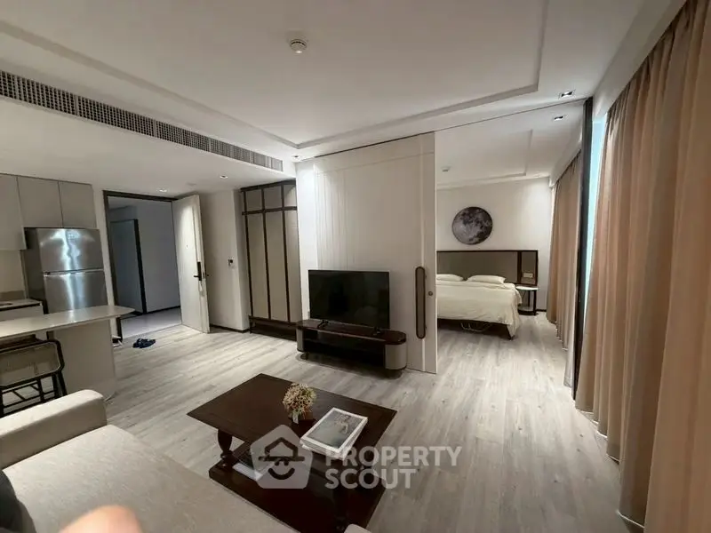 Spacious open-plan living room with modern decor and natural light