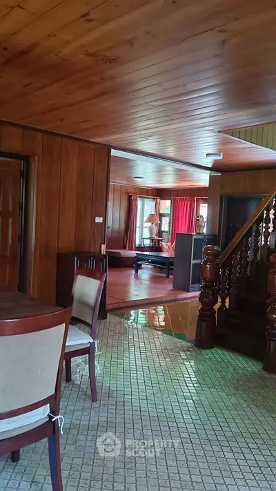 Charming wooden interior with staircase and cozy living area, perfect for a rustic home ambiance.