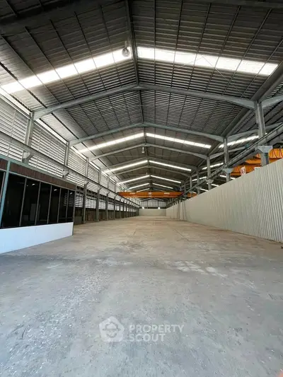 Spacious industrial warehouse with high ceilings and ample storage space.