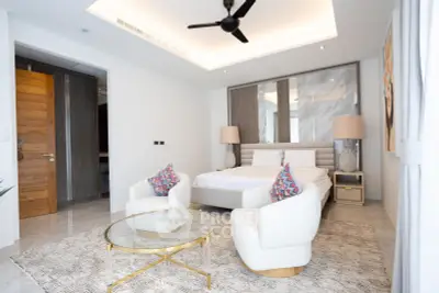 Luxurious modern bedroom with elegant decor and cozy seating area