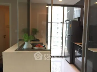Modern kitchen with sleek appliances and open layout in a high-rise apartment.