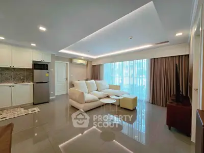 Spacious modern living room with open kitchen and elegant furnishings