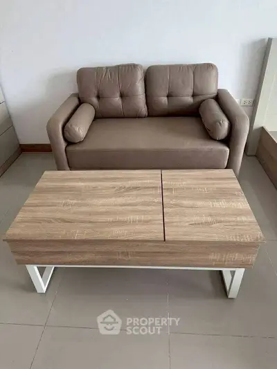 Modern living room with stylish sofa and wooden coffee table on tiled floor.