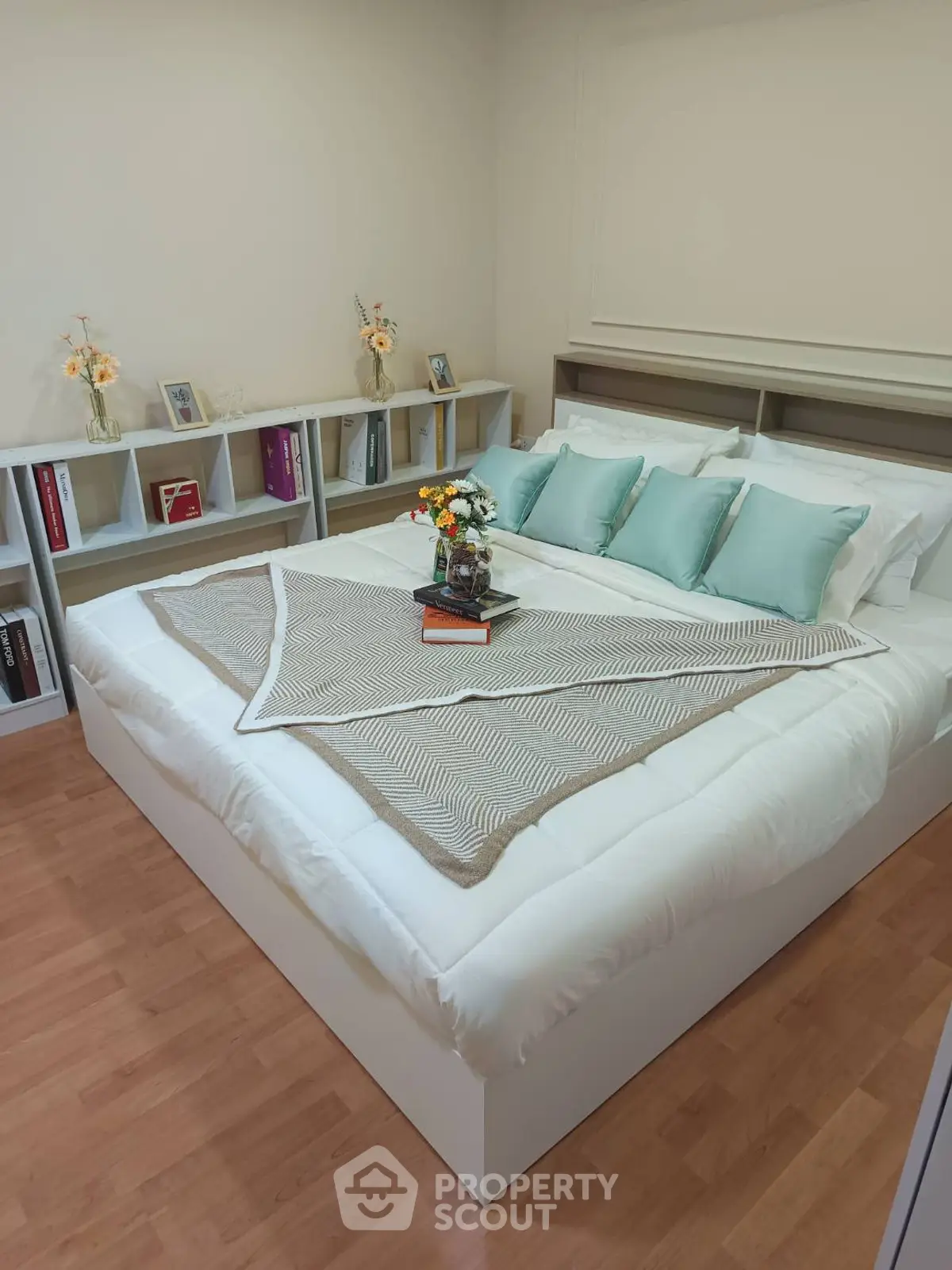 Cozy bedroom with elegant decor and ample storage space, featuring a stylish bed and decorative shelving.