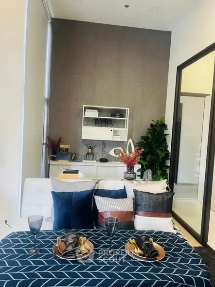 Stylish modern living room with elegant decor and dining setup, perfect for urban living.