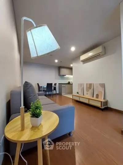 Modern living room with stylish decor and open kitchen layout in a cozy apartment.