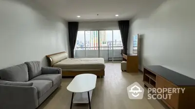 Spacious studio apartment with modern furnishings and city view balcony