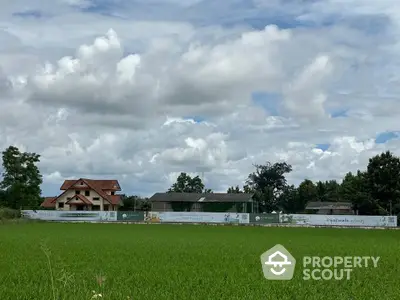 Charming countryside property with lush green fields and traditional architecture under a vast sky.