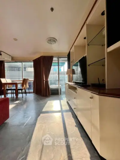 Spacious living room with modern furniture and large windows offering ample natural light.