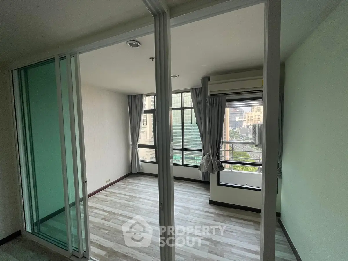 Spacious corner unit with large windows offering a stunning city view, perfect for modern living.
