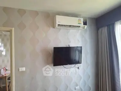 Modern living room with wall-mounted TV and air conditioning unit, featuring stylish wallpaper and natural light.