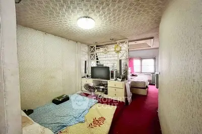 Cozy bedroom with unique ceiling design and vibrant red carpet