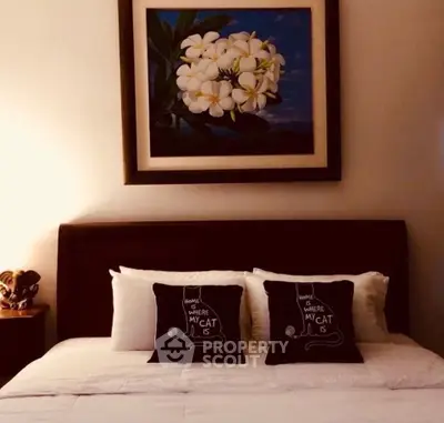 Cozy bedroom with elegant floral artwork and stylish pillows